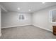 Finished basement with neutral carpet, recessed lighting, and window providing natural light at 6073 W Adriatic Pl, Lakewood, CO 80227