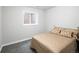 A basement bedroom features a window and a queen-sized bed with gold bedding at 6073 W Adriatic Pl, Lakewood, CO 80227