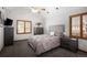 Cozy bedroom with vaulted ceilings, plush bedding, and abundant natural light at 6073 W Adriatic Pl, Lakewood, CO 80227