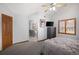 Spacious bedroom adjacent to bathroom featuring high ceilings and natural light at 6073 W Adriatic Pl, Lakewood, CO 80227