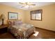 Cozy bedroom with hardwood floors features a ceiling fan and a window bringing in natural light at 6073 W Adriatic Pl, Lakewood, CO 80227