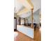 View of dining area featuring hardwood floors, wooden pillars, and modern lighting fixtures at 6073 W Adriatic Pl, Lakewood, CO 80227