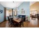 Well-lit dining area featuring wooden floors, modern chandelier, and stylish decor at 6073 W Adriatic Pl, Lakewood, CO 80227