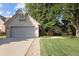 Charming brick home with a two-car garage, mature trees, and a well-manicured lawn at 6073 W Adriatic Pl, Lakewood, CO 80227