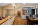 Hallway features a wood floor, beautiful pillars, and a view into the dining room at 6073 W Adriatic Pl, Lakewood, CO 80227