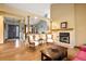 Inviting living room featuring a brick fireplace, hardwood floors and natural light at 6073 W Adriatic Pl, Lakewood, CO 80227