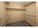 Empty walk-in closet with multiple shelves and ample storage space at 6073 W Adriatic Pl, Lakewood, CO 80227