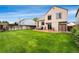 Well-maintained backyard with lush green grass, a concrete patio with dining furniture and a privacy fence at 7796 Xavier Ct, Westminster, CO 80030