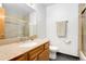 Bathroom featuring granite countertops, framed mirror and glass shower doors, complimented by neutral wall and floor tones at 7796 Xavier Ct, Westminster, CO 80030