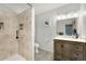 Modern bathroom showcasing a walk-in shower with tiled walls, granite vanity, neutral walls and flooring at 7796 Xavier Ct, Westminster, CO 80030