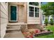 Welcoming entrance with brick accents, steps leading to the front door, and potted plants enhancing the curb appeal at 7796 Xavier Ct, Westminster, CO 80030