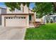 Charming two-story home featuring a well-manicured lawn and attached two-car garage, offering curb appeal at 7796 Xavier Ct, Westminster, CO 80030