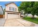 Charming two-story home with a well-maintained lawn and a large driveway leading to a two-car garage at 7796 Xavier Ct, Westminster, CO 80030