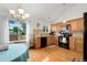 Bright kitchen with stainless steel appliances, wood cabinets, and a large window overlooking the backyard at 7796 Xavier Ct, Westminster, CO 80030