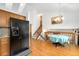 Well-lit kitchen with a dining area, featuring modern appliances and a staircase leading to the upper level at 7796 Xavier Ct, Westminster, CO 80030