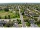 An aerial view of the neighborhood shows mature trees, a park, and a view of the city skyline at 301 Fairfax St, Denver, CO 80220
