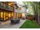 This well-maintained backyard features a stone patio, a hot tub, and an upper level balcony at 301 Fairfax St, Denver, CO 80220