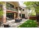 Beautiful backyard with a stone patio, outdoor dining set, barbecue grill, and lush green lawn at 301 Fairfax St, Denver, CO 80220