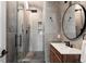 Modern bathroom showcasing gray tiling, glass-enclosed shower, a sleek wooden vanity, and black fixtures at 301 Fairfax St, Denver, CO 80220