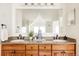 Bathroom vanity features a double sink, granite countertop, and ample cabinet space with a large mirror at 301 Fairfax St, Denver, CO 80220