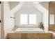 Bright bathroom featuring a soaking tub with tiled surround and a window providing natural light at 301 Fairfax St, Denver, CO 80220