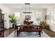 Bright dining room with a wooden table, elegant chandelier, and large windows at 301 Fairfax St, Denver, CO 80220