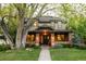 Charming two-story brick home with a large front yard and mature tree at 301 Fairfax St, Denver, CO 80220