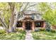 Charming two-story home with brick accents, a manicured lawn, and mature landscaping around the front at 301 Fairfax St, Denver, CO 80220