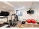 Home gym featuring treadmill, weight machine, and mirrored wall, providing a dedicated fitness space at 301 Fairfax St, Denver, CO 80220