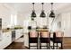 Bright kitchen featuring white cabinets, granite countertops, and a large island at 301 Fairfax St, Denver, CO 80220