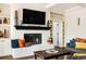 Living room fireplace with painted brick, mantle, and custom shelving on both sides at 301 Fairfax St, Denver, CO 80220