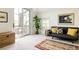 Bright living room featuring a sliding glass door to the balcony with ample sunlight and a neutral color scheme at 301 Fairfax St, Denver, CO 80220