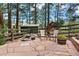 Scenic backyard featuring a rock water feature, flower planters, and a wooden fence, offering a serene outdoor retreat at 4515 Red Rock Dr, Larkspur, CO 80118
