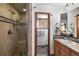 Well-appointed bathroom with a tiled shower, vanity, and modern fixtures, offering a blend of style and convenience at 4515 Red Rock Dr, Larkspur, CO 80118