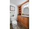 Well-maintained bathroom features wood cabinetry, decorative shelving and a modern sink at 4515 Red Rock Dr, Larkspur, CO 80118