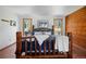 Comfortable bedroom featuring a unique wood bed frame, natural light, and inviting decor for a serene resting space at 4515 Red Rock Dr, Larkspur, CO 80118