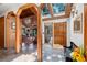 Bright foyer with wooden ceiling beams, skylight, and a view of the living room beyond at 4515 Red Rock Dr, Larkspur, CO 80118