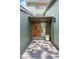 A welcoming front entrance with a wood door, sidelight, and tasteful potted plants at 4515 Red Rock Dr, Larkspur, CO 80118