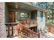 Charming front porch with seating area, wooden railings, and attractive exterior at 4515 Red Rock Dr, Larkspur, CO 80118