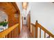 Hallway with wooden accents and beams, showcasing the home's unique architectural details with wood flooring at 4515 Red Rock Dr, Larkspur, CO 80118