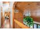 Upstairs hallway showing the wood ceiling and architectural details, with views into other living spaces at 4515 Red Rock Dr, Larkspur, CO 80118