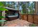 Backyard hot tub provides relaxation and privacy, enclosed by a wooden fence and lush foliage for a tranquil experience at 4515 Red Rock Dr, Larkspur, CO 80118