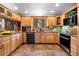 Spacious kitchen with wood cabinets, stainless appliances, granite countertops, and tile flooring at 4515 Red Rock Dr, Larkspur, CO 80118