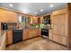 Charming kitchen with natural wood cabinets, stainless steel appliances, and granite countertops at 4515 Red Rock Dr, Larkspur, CO 80118