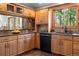 Charming kitchen with wood cabinets, granite countertops, and an eat-in nook with natural light at 4515 Red Rock Dr, Larkspur, CO 80118