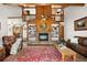 Cozy living room with a stone fireplace, built-in bookshelves, and a soaring wood-clad ceiling at 4515 Red Rock Dr, Larkspur, CO 80118