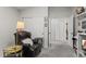 This bedroom features neutral walls, a black leather chair, and ample closet space at 8040 E Dartmouth Ave # 16, Denver, CO 80231