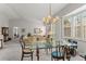 Bright dining room featuring a modern chandelier, bay window and neutral-toned walls at 8040 E Dartmouth Ave # 16, Denver, CO 80231