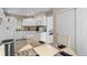Bright eat-in kitchen featuring white cabinetry, tile floors, and modern appliances at 8040 E Dartmouth Ave # 16, Denver, CO 80231