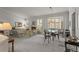 Spacious living room featuring a fireplace, large windows and an adjacent dining area at 8040 E Dartmouth Ave # 16, Denver, CO 80231